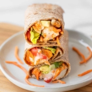 Super easy and delicious healthy buffalo chicken caesar wraps. Ready in 15 minutes, this easy on-the-go lunch or dinner recipe is perfect for meal prep, fitness lovers, and families. They are loaded with chicken, avocado, buffalo sauce, whole wheat wraps, Caesar dressing, and lots of fresh veggies! Made gluten free, dairy free, low calorie, paleo, high protein, and low fat.