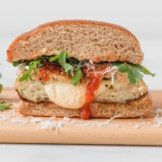Best mozzarella cheese stuffed chicken burger. So juicy and mouthwatering. The melted cheese is pouring out of the center of the burger! Try these healthy stuffed chicken parmesan burgers that are loaded with good for you ingredients like lean ground chicken, gluten free panko, arugula, mozzarella cheese, and marinara sauce. Such an easy, flavorful, and simple dinner recipe to up your burger game! Perfect for kids, families, athletes, and meal prep!