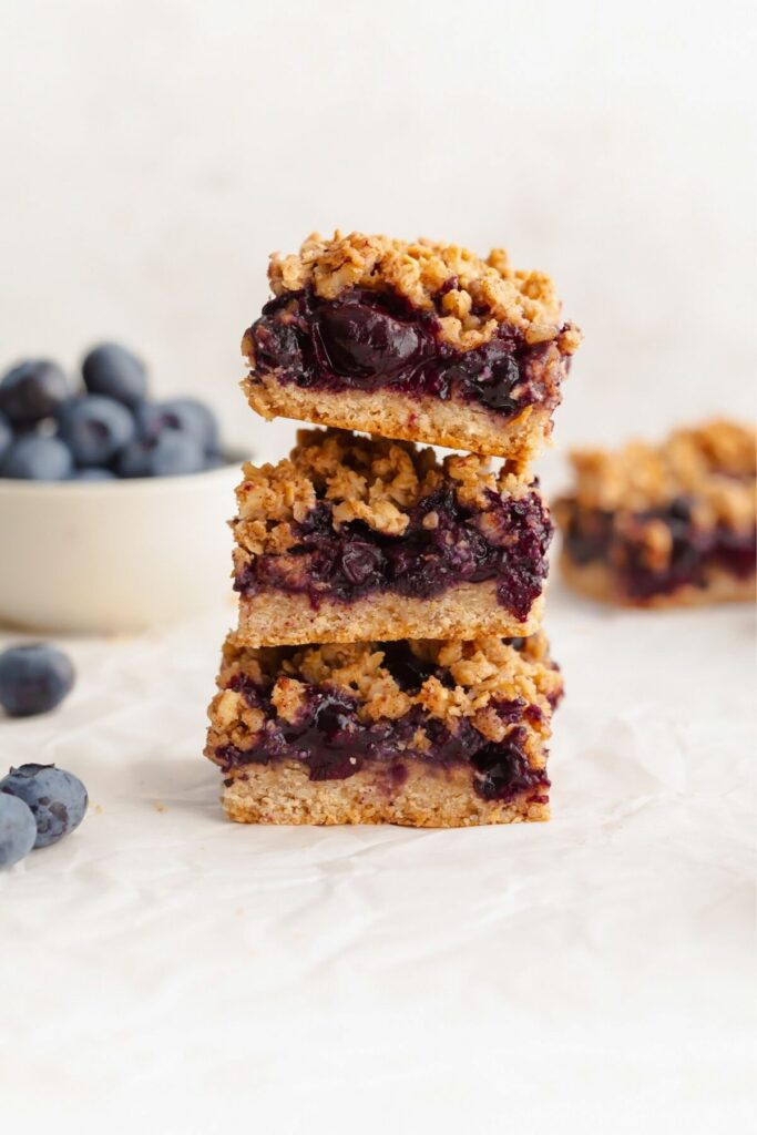 blueberry oat bars topped with a crisp crumble and stacked on top of each other