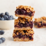 Healthy blueberry crumble bars topped with oatmeal crisp and stacked on top of each other. Easy vegan and gluten free blueberry pie bars.