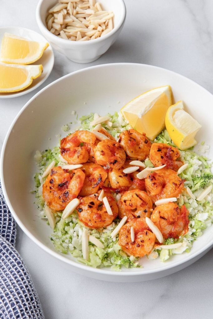 Super easy and flavorful harissa shrimp recipe. Marinated in a little honey for natural sweetness and topped with crunchy almonds, this dinner is the perfect healthy dinner.