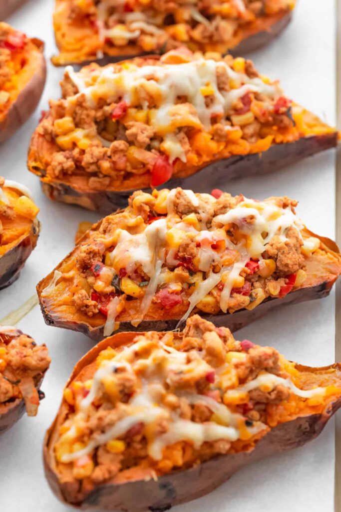Loaded healthy sweet potato taco boats for a filling and delicious dinner. Topped with cheese, spices, and salsa, this stuffed sweet potato recipe. is incredible!