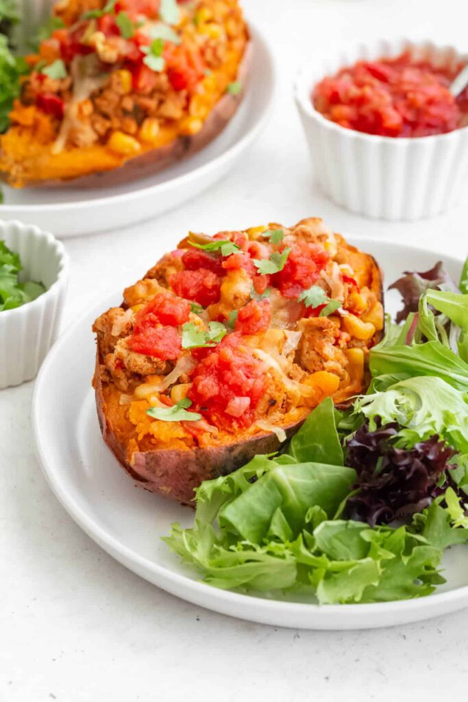 Mexican easy taco stuffed sweet potato boats to take your taco night to a new fun and healthy level! This simple dinner is nutritious, saucy, cheesy, gluten free, and grain free! Super easy to make and loaded with lean protein, fiber, and vitamins. Ideal for meal prepping, family dinners, and comforting meals! Recipe by Healthful Blondie.