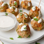 Incredibly easy, juicy, and delicious healthy broccoli cheddar turkey meatball poppers drizzles with caesar dressing or ranch dressing. Simple meatball skewer recipe.