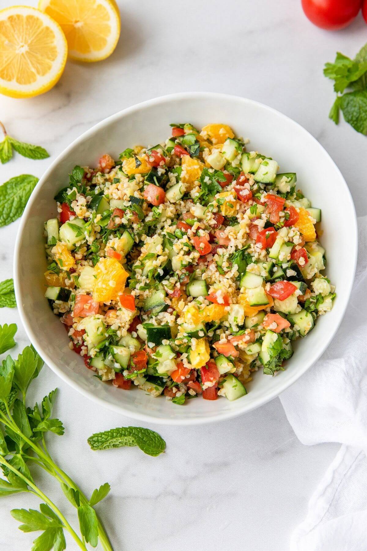 healthy Greek tabbouleh salad with orange, cucumber, and tomato