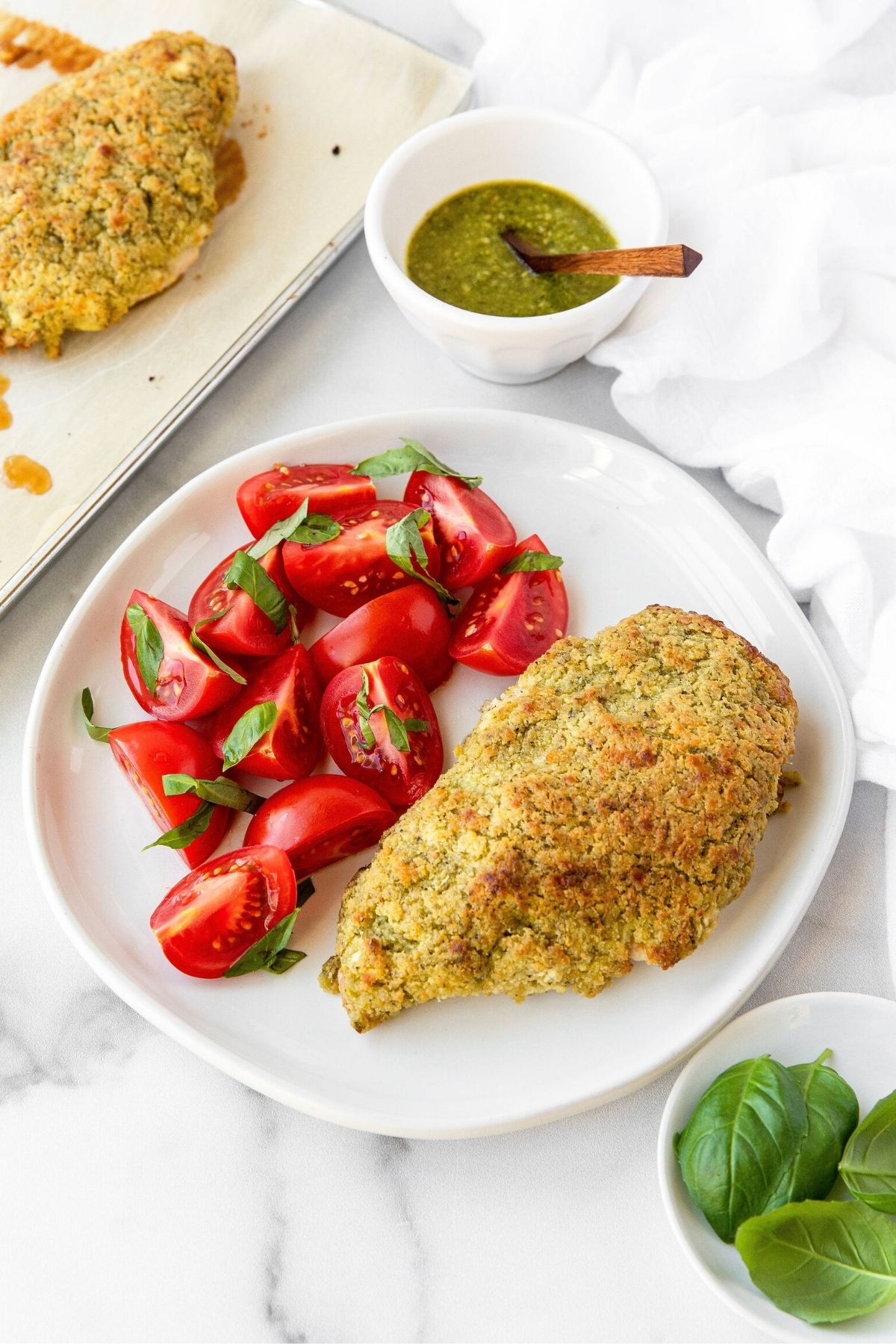 Healthy crusted chicken with pesto, goat cheese, and basil