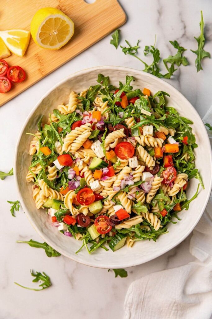 healthy Greek chickpea pasta salad in large white serving bowl