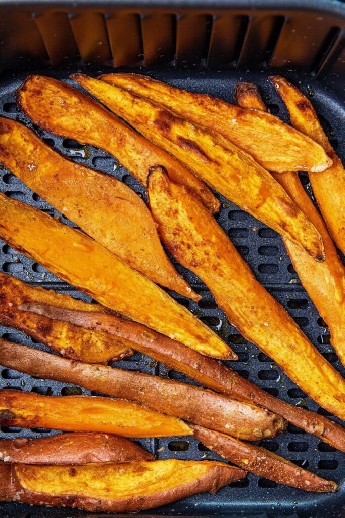 air fryer sweet potato wedges in air fryer basket after cooking