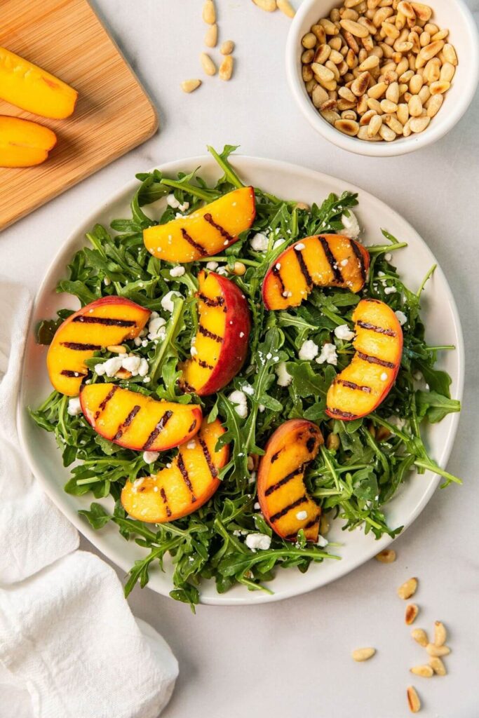 grilled peaches on arugula and goat cheese salad
