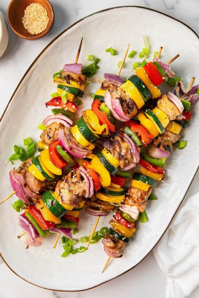 healthy grilled honey soy chicken thigh skewers on a large serving plate