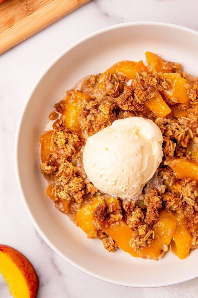 close up of healthy peach crisp with streusel topping
