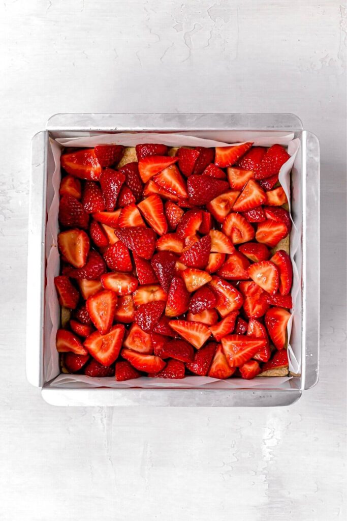 fresh strawberries on top of crust in baking dish