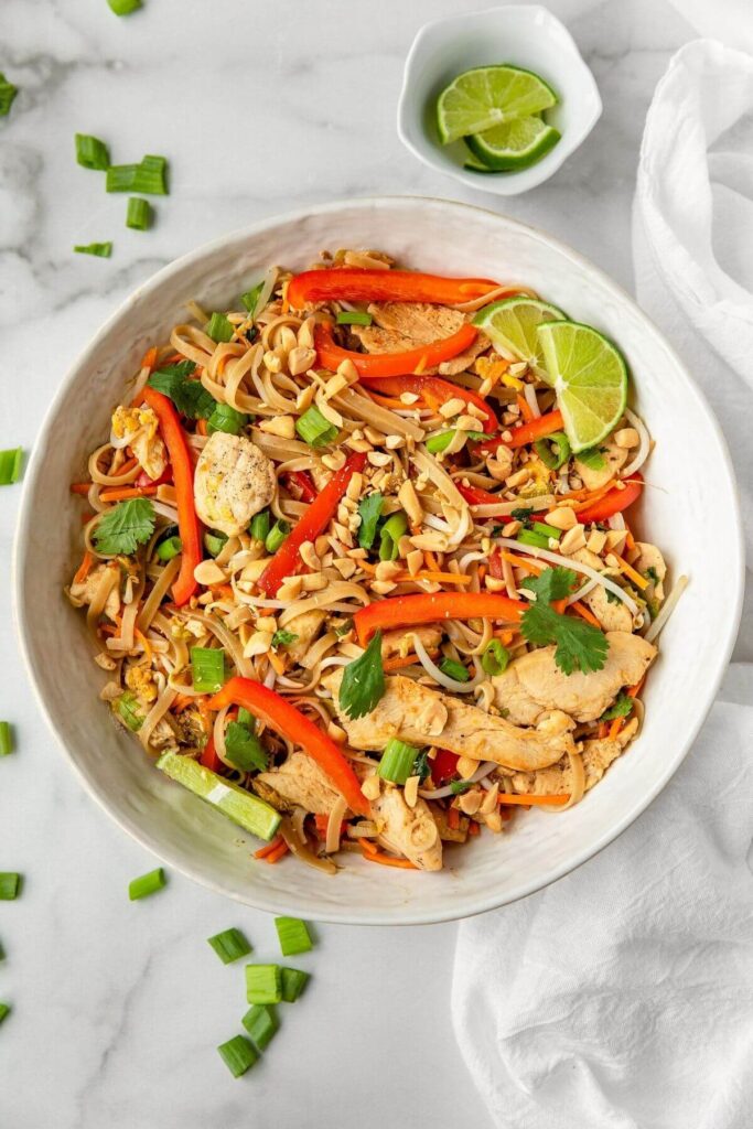 healthy chicken pad thai in large serving bowl