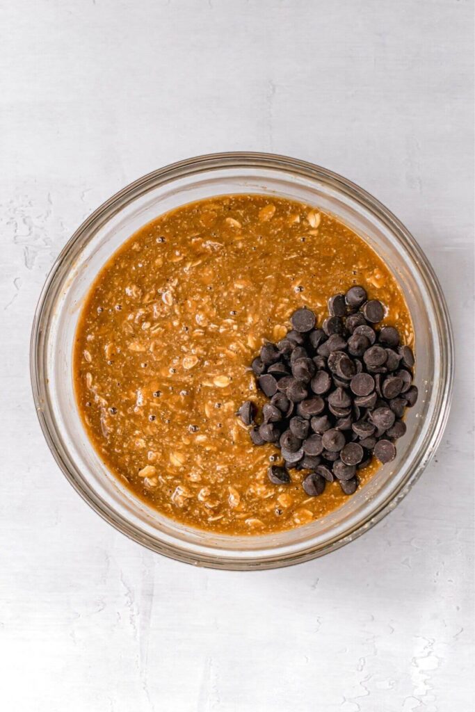 pumpkin oatmeal bar batter with chocolate chips in a mixing bowl
