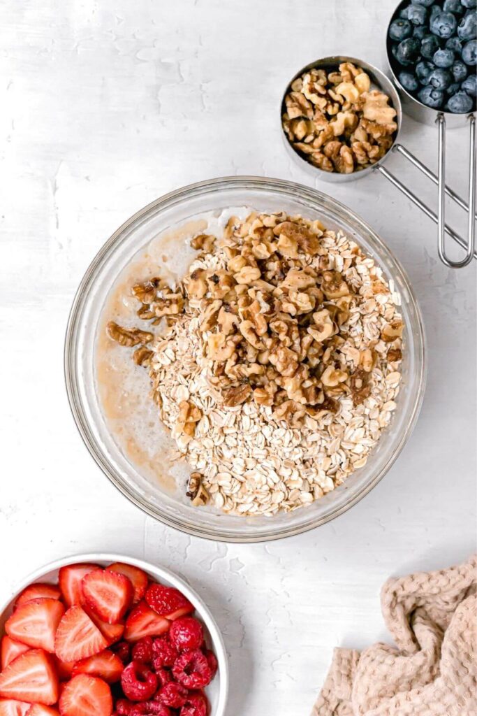 rolled oats and walnuts added to vegan baked oats mixture