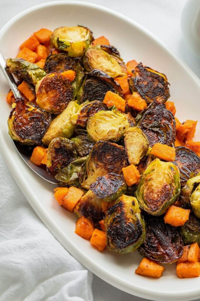 close up of crispy roasted maple sweet potato and brussels