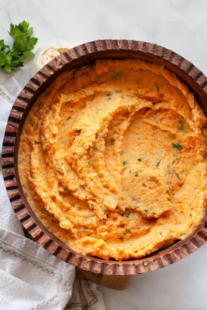 mashed cauliflower and sweet potatoes in a bowl