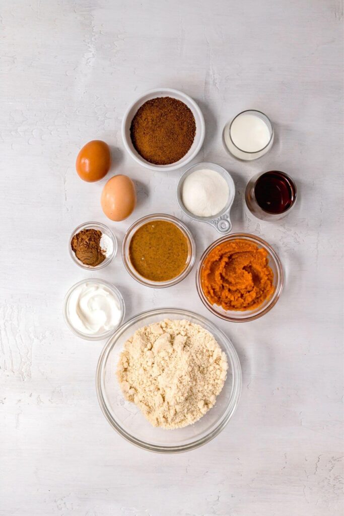 ingredients in pumpkin protein muffins in small bowls