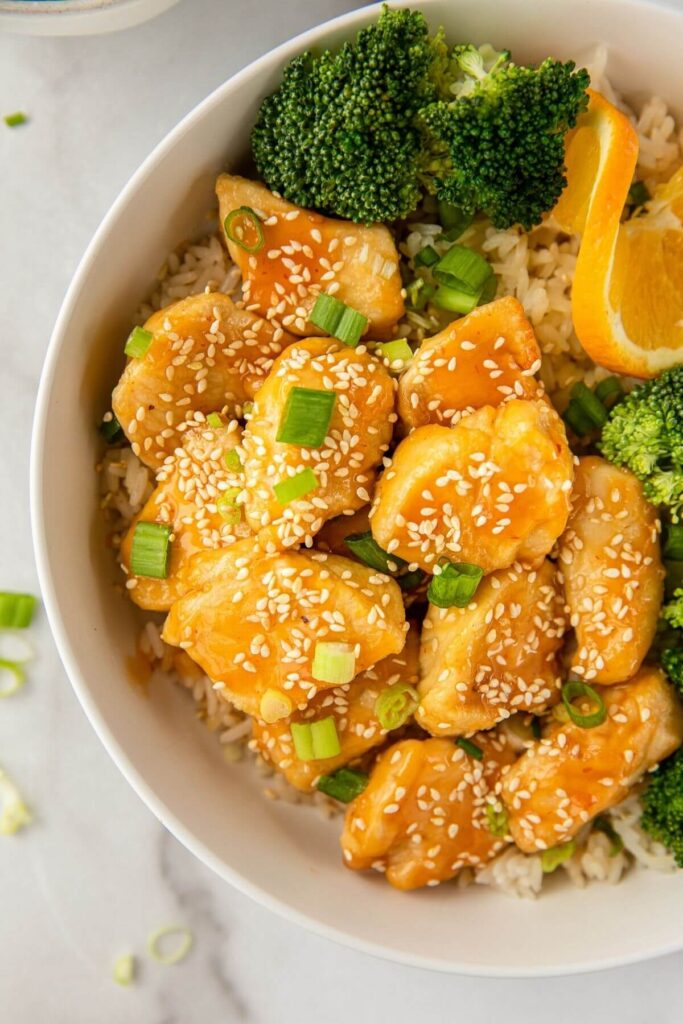 close up of healthy air fryer orange chicken with sesame seeds on top
