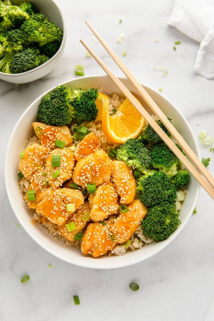 air fried orange chicken with broccoli and brown rice in a serving bowl
