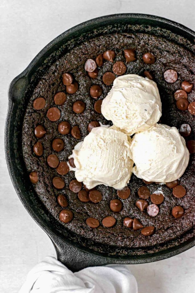 vegan skillet brownie with vanilla ice cream on top