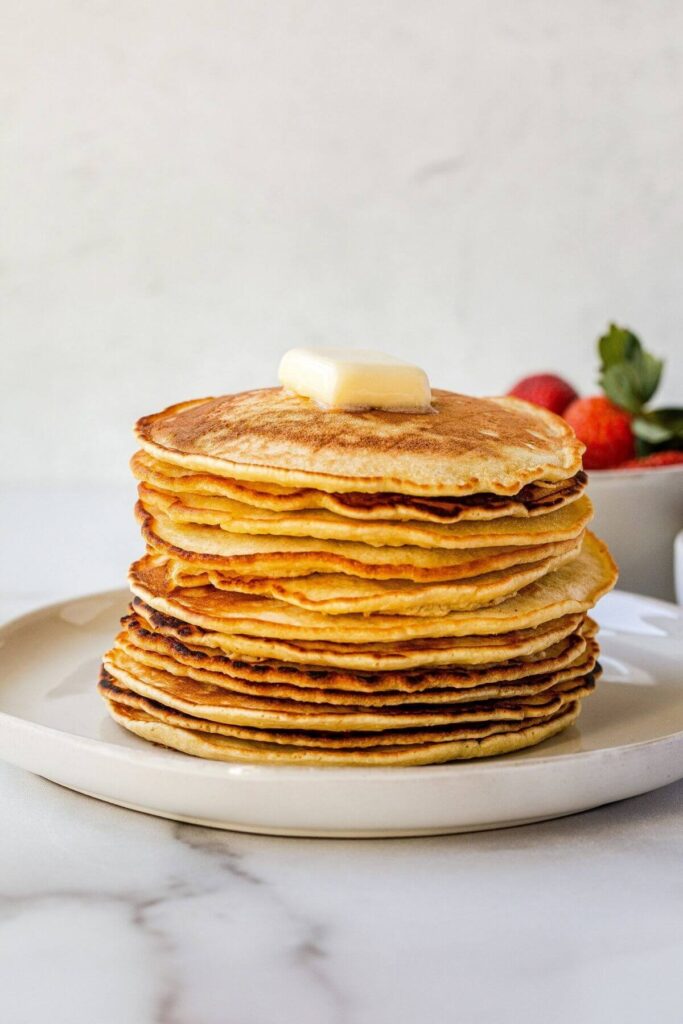 plain stack of oat milk pancakes with butter on top