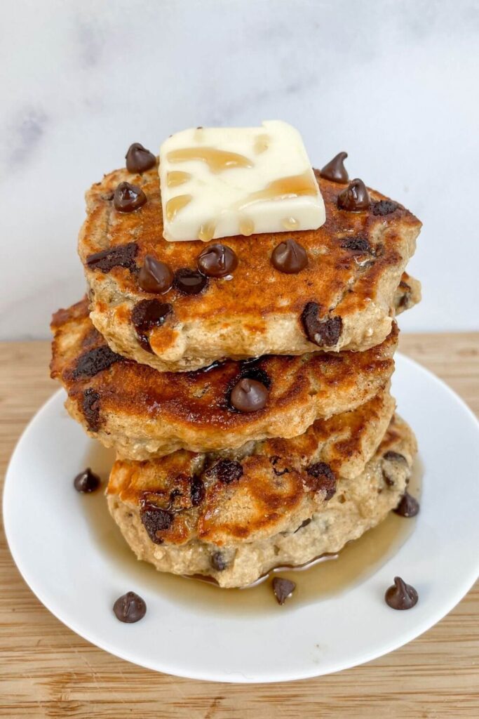 Stack of chunky monkey chocolate chip pancakes with butter on top