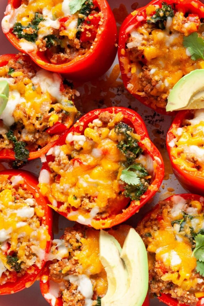 healthy Mexican ground turkey kale quinoa stuffed bell peppers with avocado slices