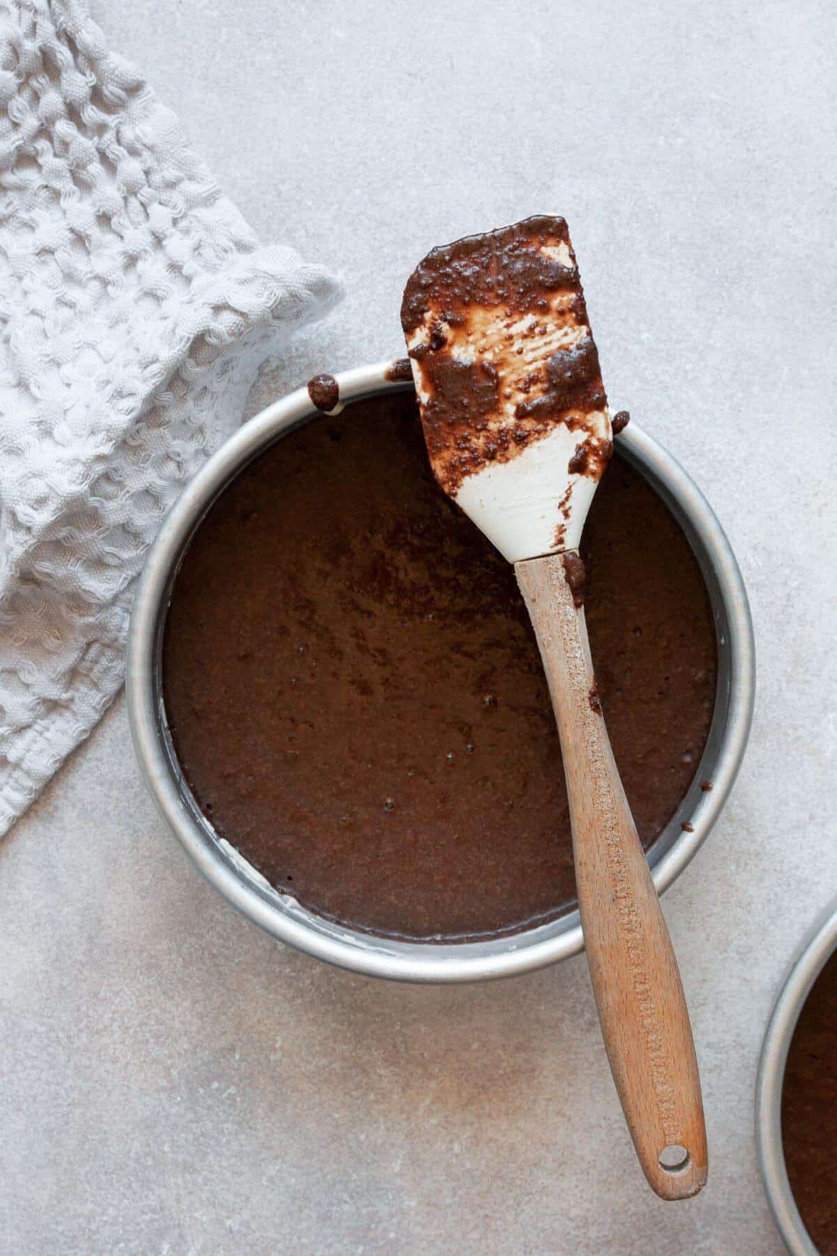 Almond flour chocolate cake batter in a 6-inch round cake pan.