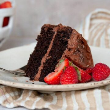 healthy, gluten-free almond flour chocolate cake with homemade chocolate buttercream and fresh berries