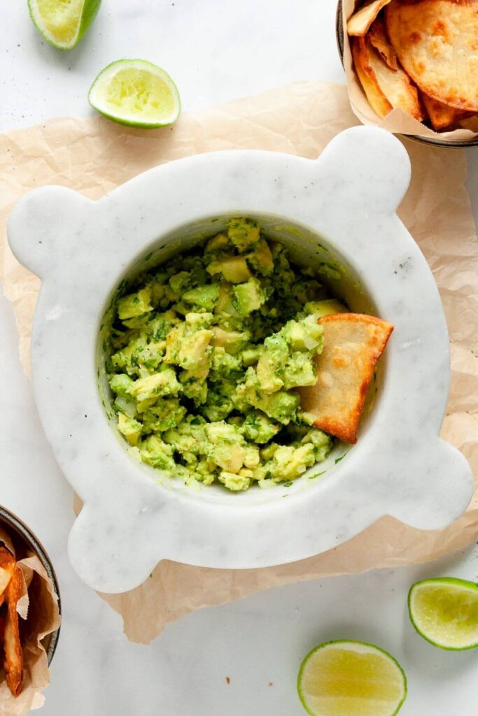 4 ingredient guacamole in a bowl with a tortilla chip