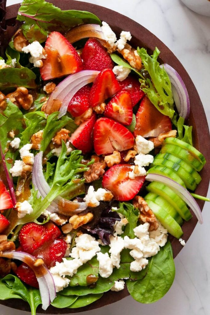close up of strawberry goat cheese salad with balsamic dressing
