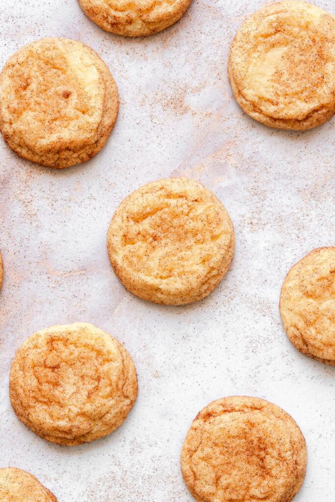snickerdoodles without cream of tartar on parchment paper after baking