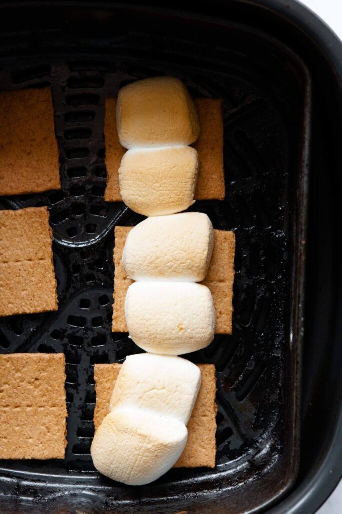golden marshmallow s'mores inside air fryer basket after being air fried