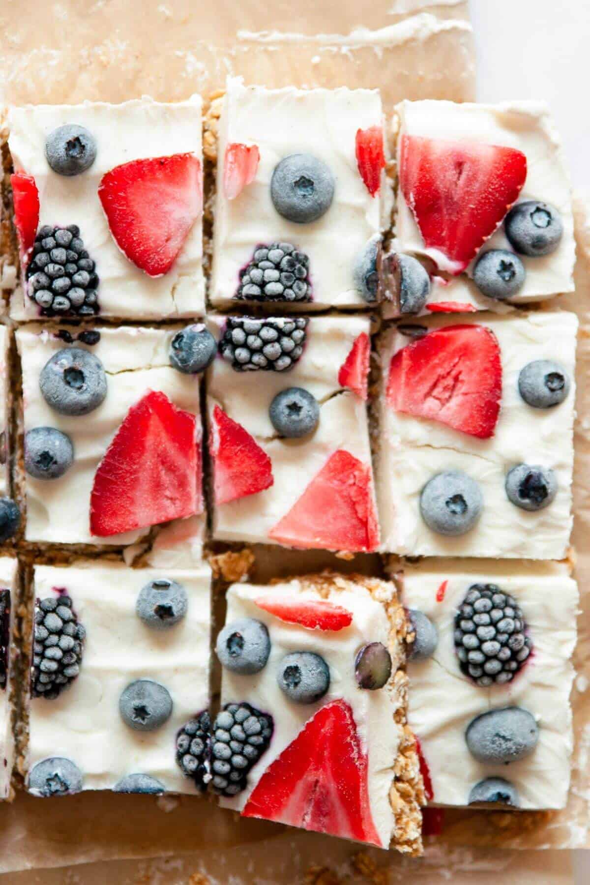 Frozen Greek yogurt bars with a chewy granola base and fresh berries on top.
