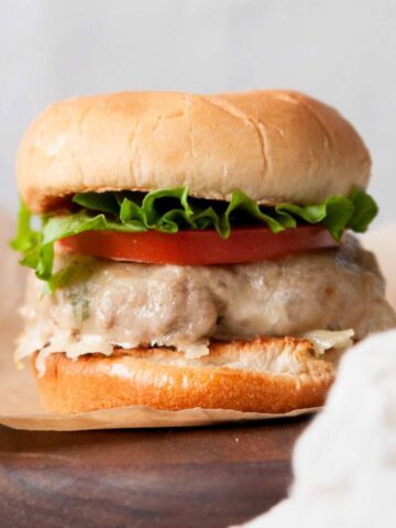 easy and extra juicy grilled turkey burger with melted cheese, crisp lettuce, and ripe tomato slices on a toasted bun