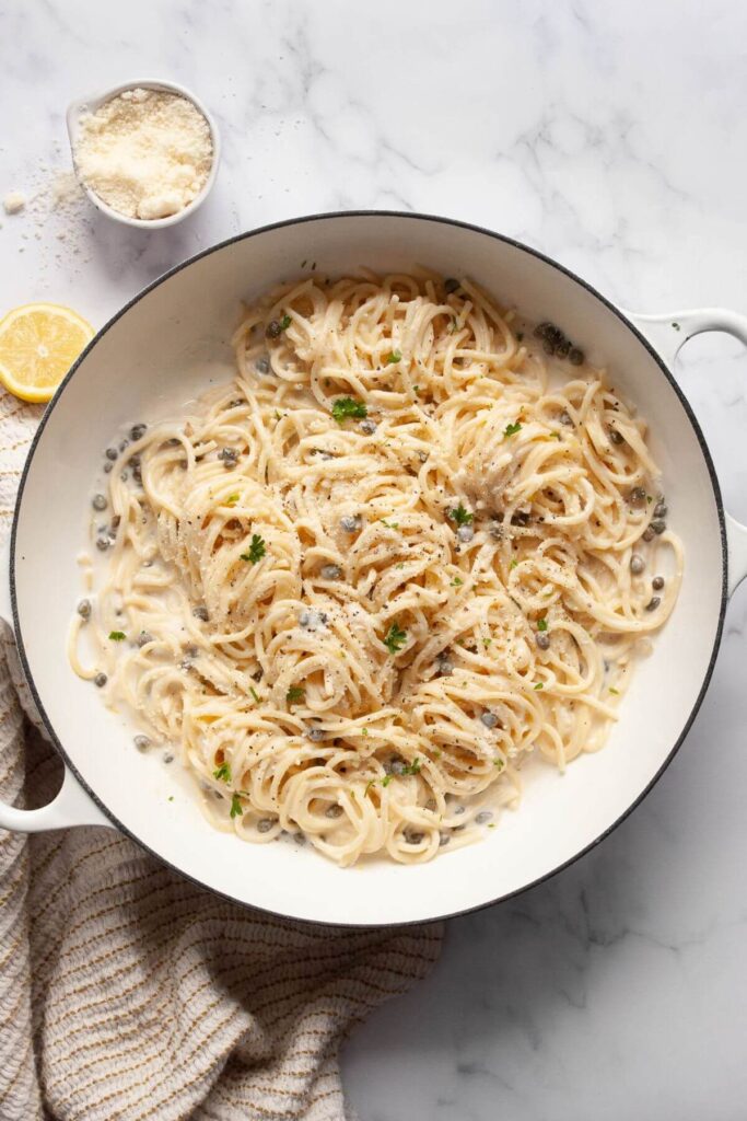 creamy healthy lemon caper pasta with black pepper and fresh parsley on top