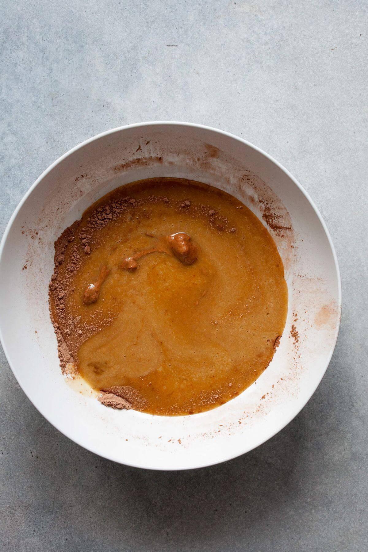 Wet ingredients for gluten-free chocolate cupcakes mixed in a bowl.