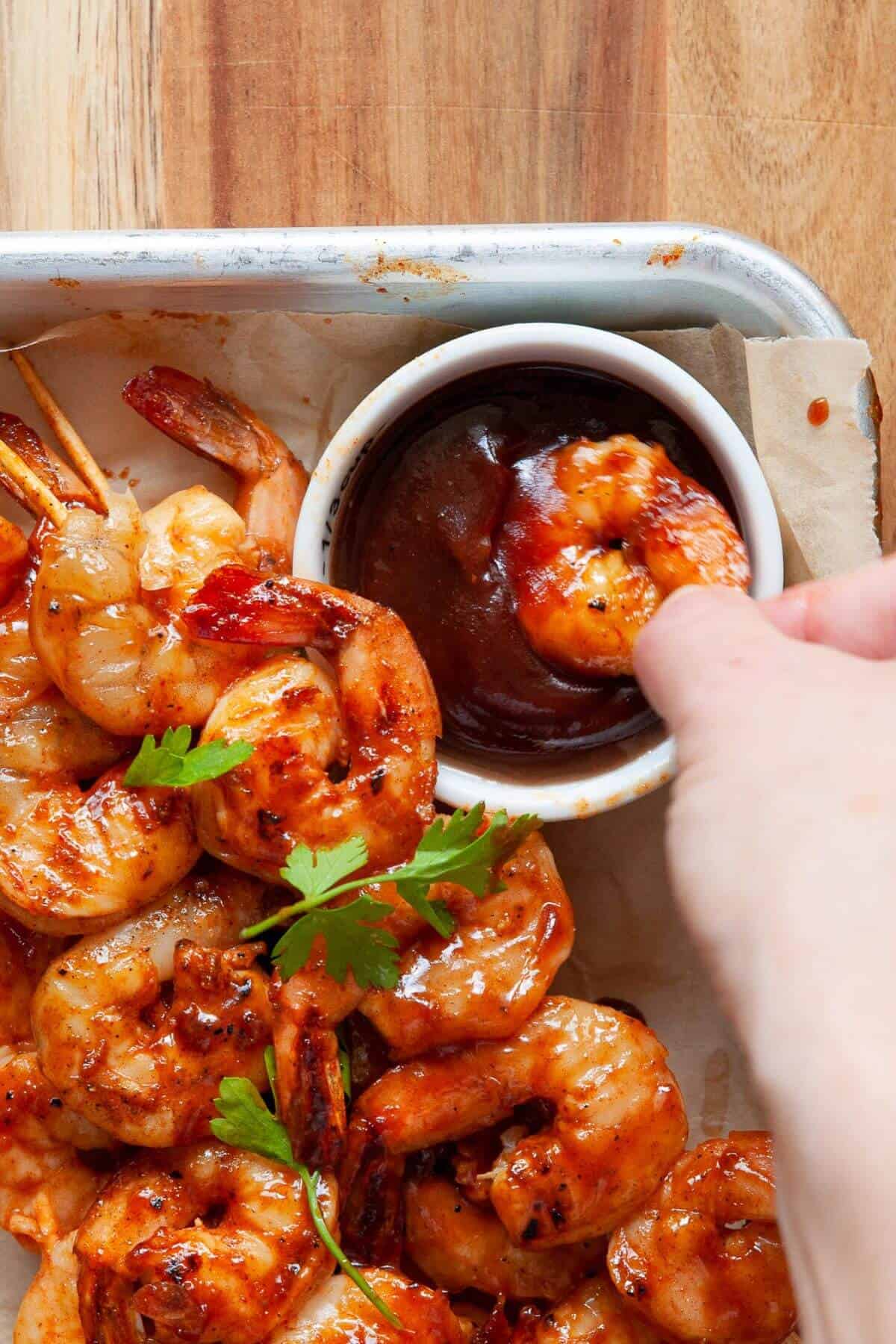 Dripping grilled shrimp in bbq sauce.