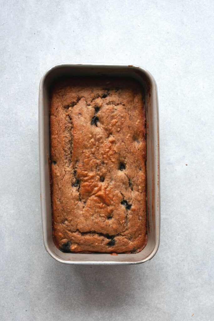 healthy blueberry banana bread baked in a loaf tin