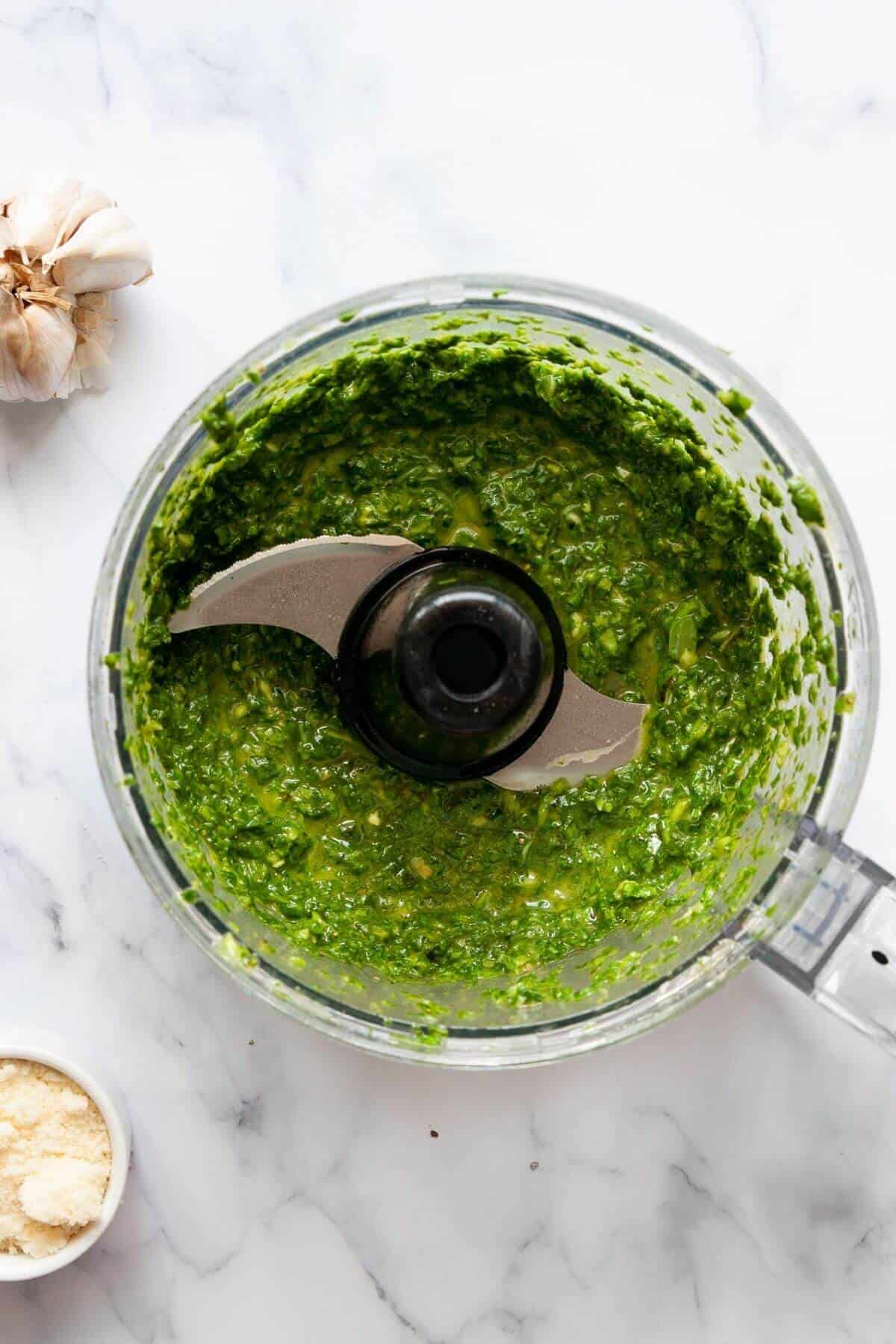 Creamy nut-free pesto sauce made with basil and spinach in a food processor.