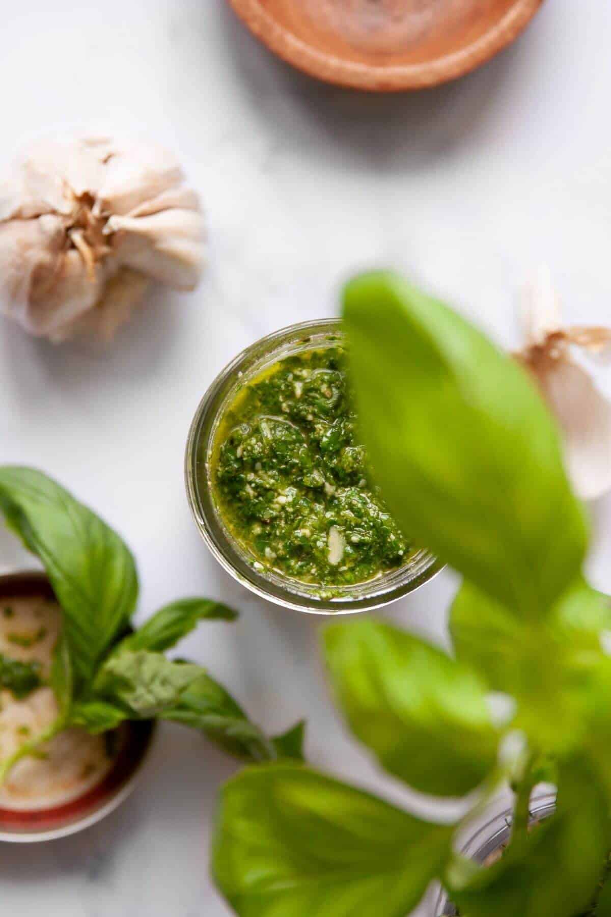 Homemade pesto without pine nuts in a glass jar ready to serve.