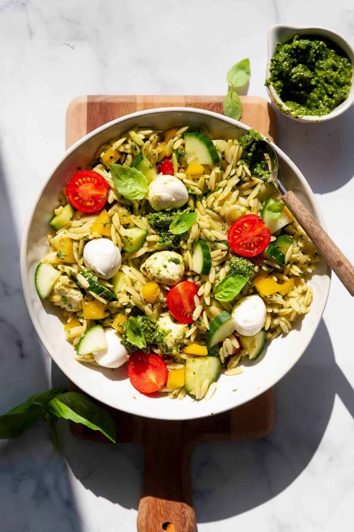 orzo pesto salad with mozzarella cheese, tomatoes and cucumber