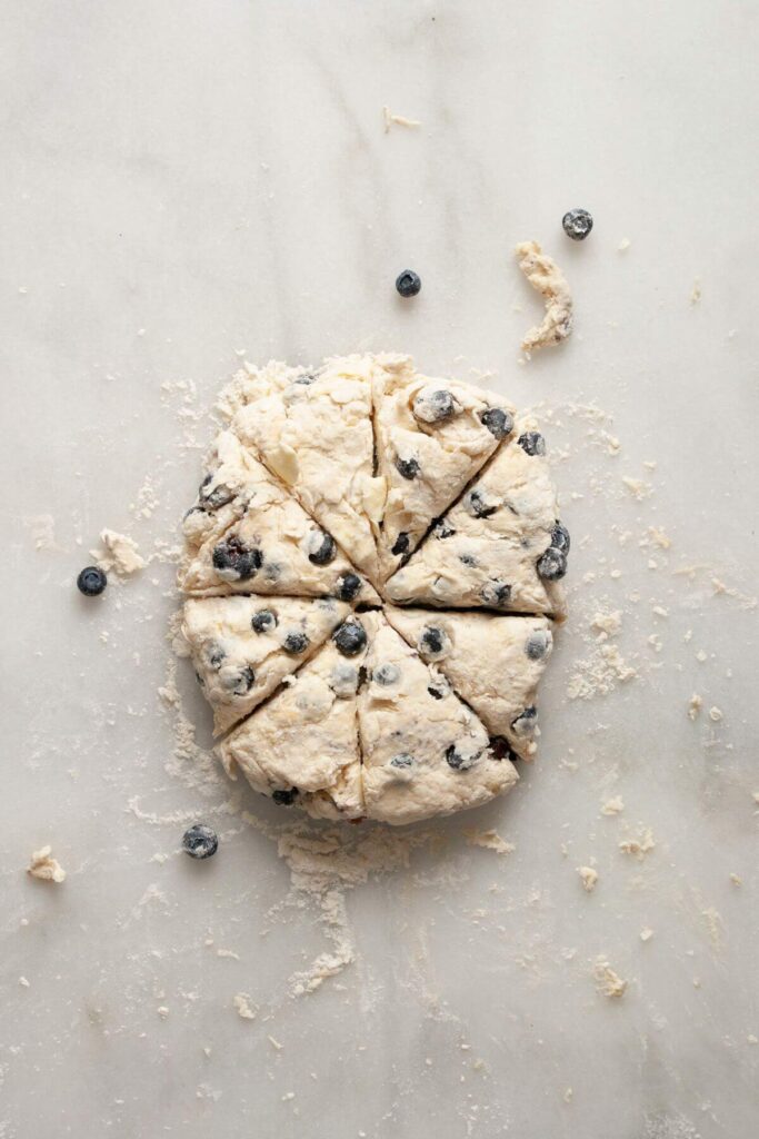 blueberry scone dough cut into 8 pieces before baking