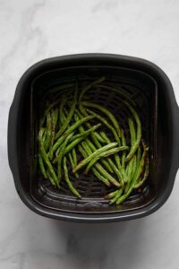crispy green beans in air fryer basket