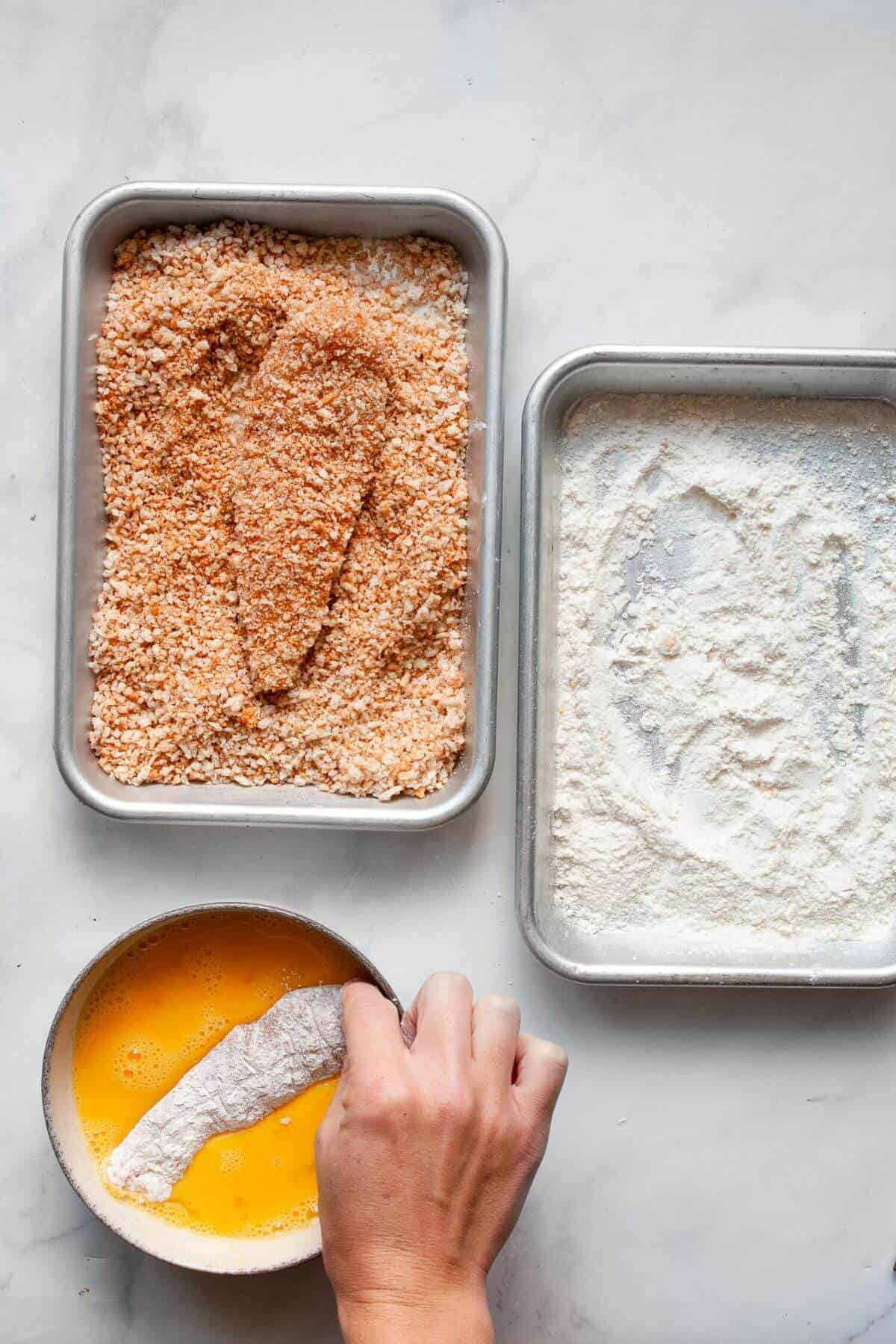 Dredging chicken tenders in flour, then in egg wash, then coating with panko breadcrumbs.