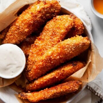 hot honey chicken tenders in a bowl with ranch