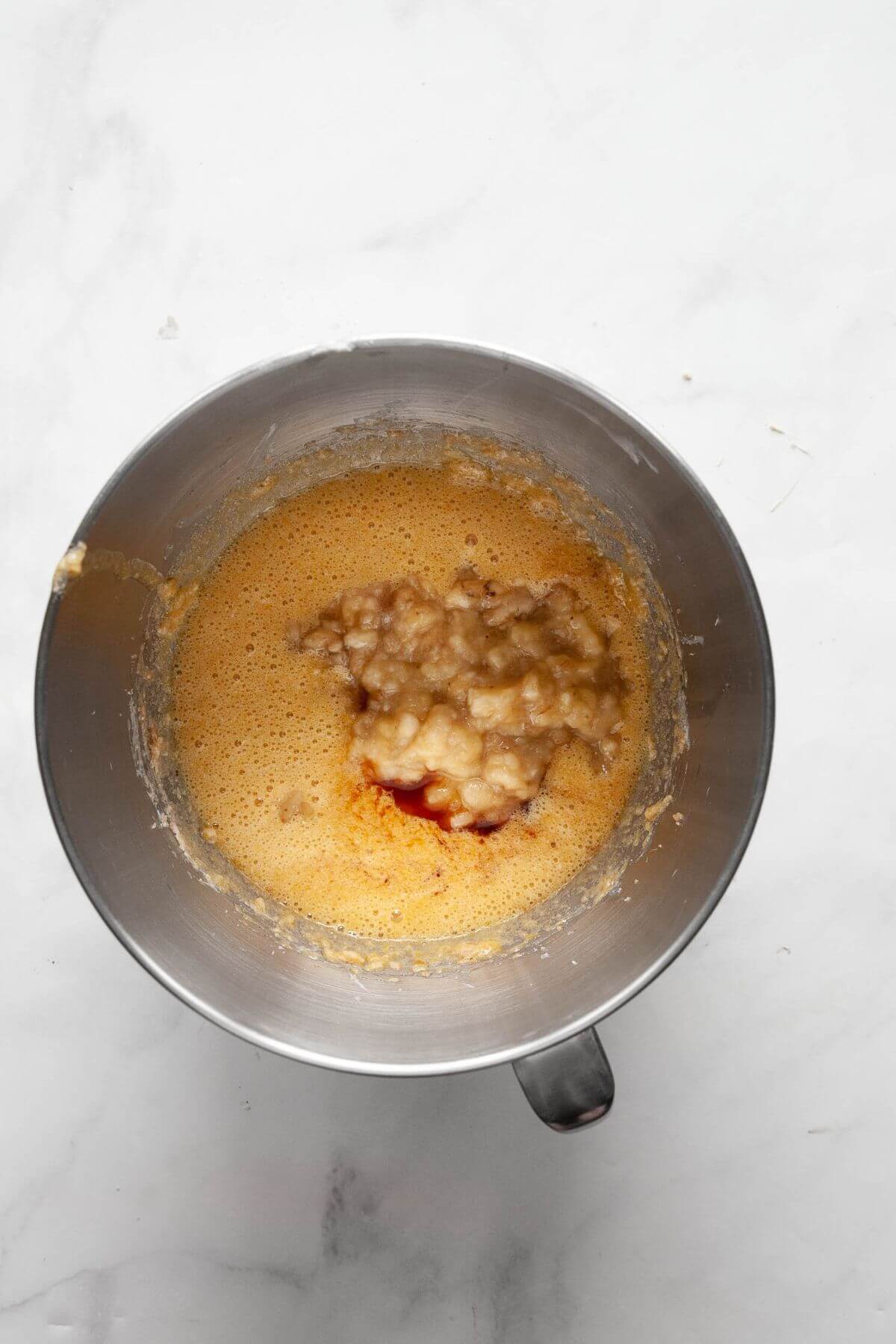 Eggs, vanilla, and mashed banana added to the creamed butter mixture.