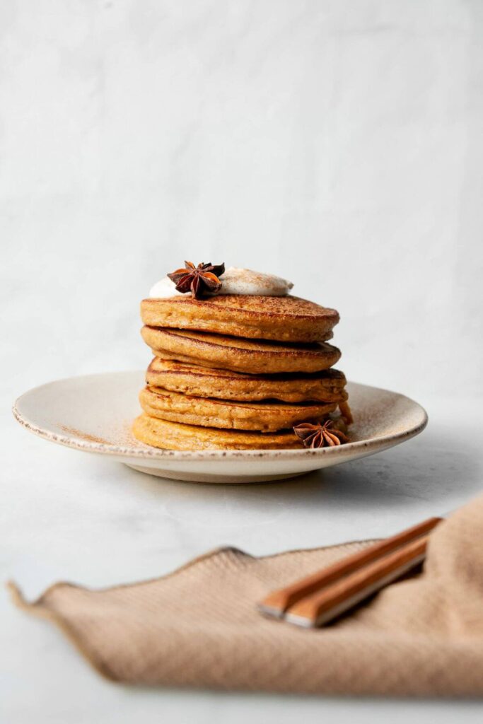 a stack of blender oatmeal pumpkin protein pancakes on a plate