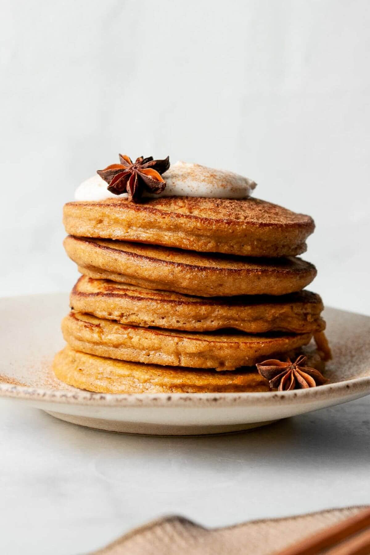 Healthy oatmeal protein pumpkin pancakes with crispy edges and super fluffy centers.
